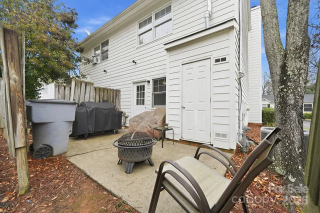 a view of a patio with chair and tables back yard of the house