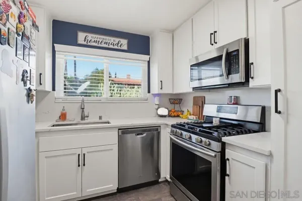 a kitchen with a table chairs sink and refrigerator