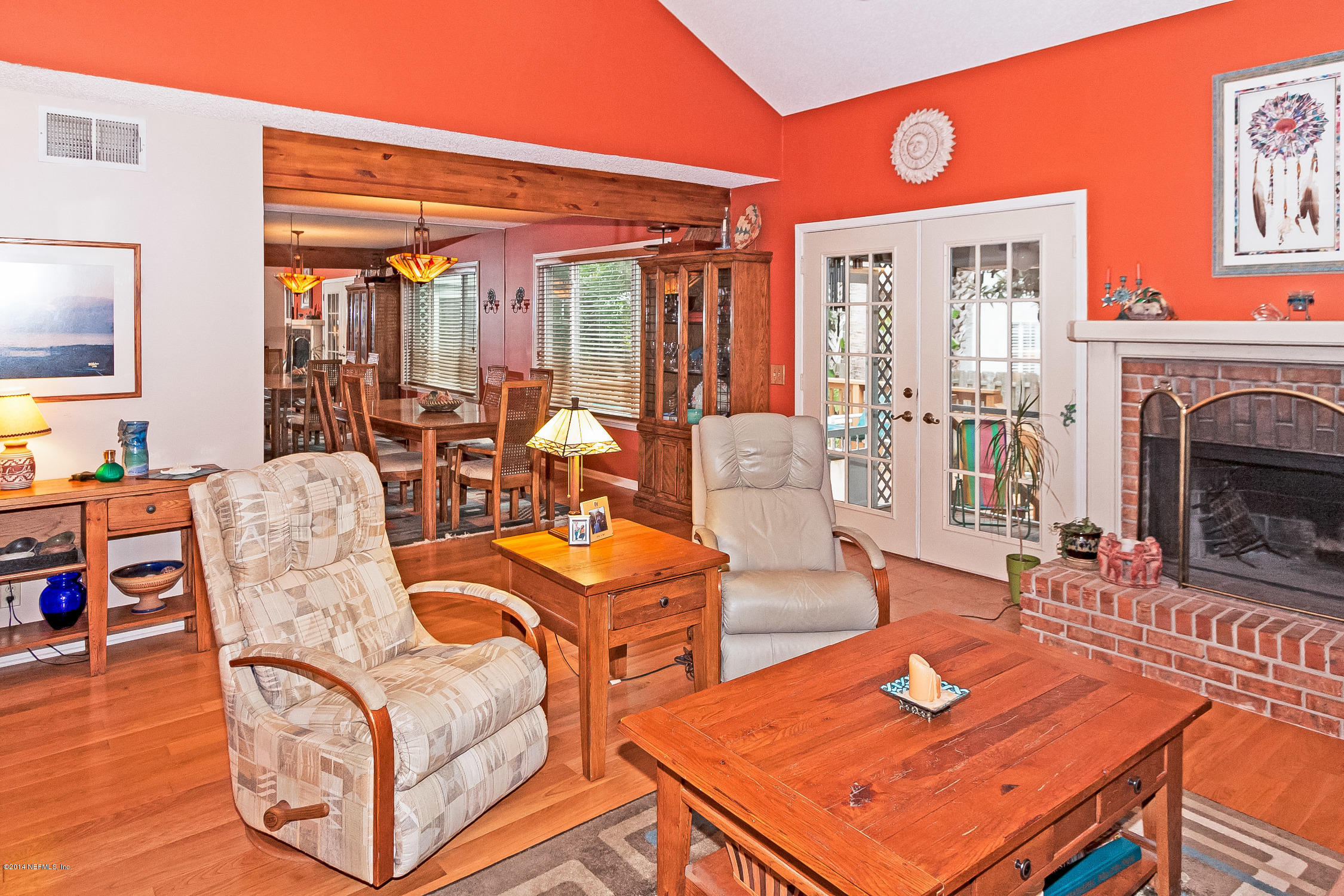 1969 Seminole Road Atlantic Beach, FL 32233 - Photo 11 of 36 a living room with furniture a large window and a fireplace