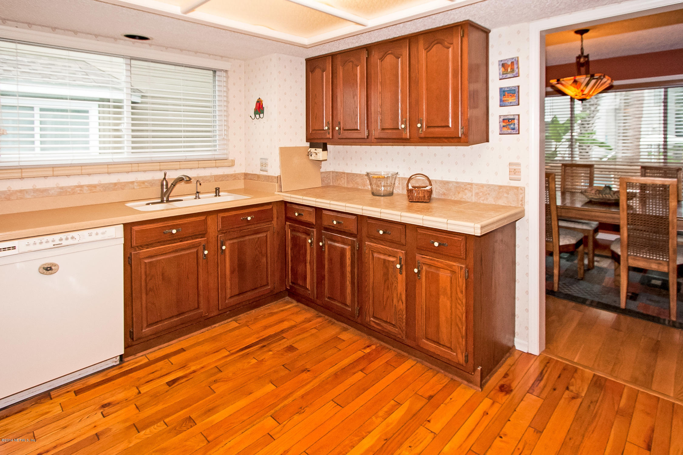 1969 Seminole Road Atlantic Beach, FL 32233 - Photo 13 of 36 a kitchen with a sink cabinets and wooden floor
