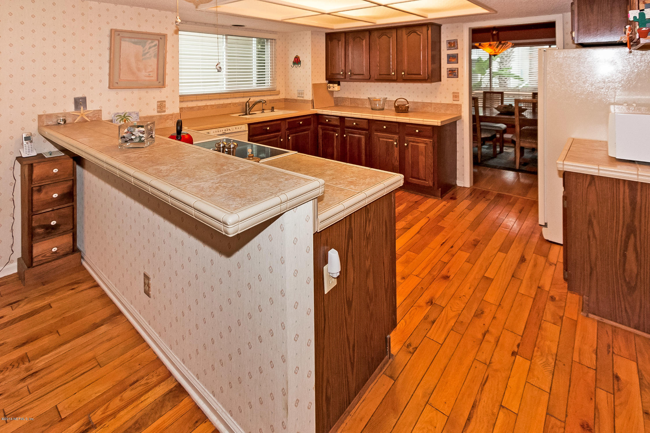 1969 Seminole Road Atlantic Beach, FL 32233 - Photo 14 of 36 a kitchen with stainless steel appliances granite countertop a sink and cabinets