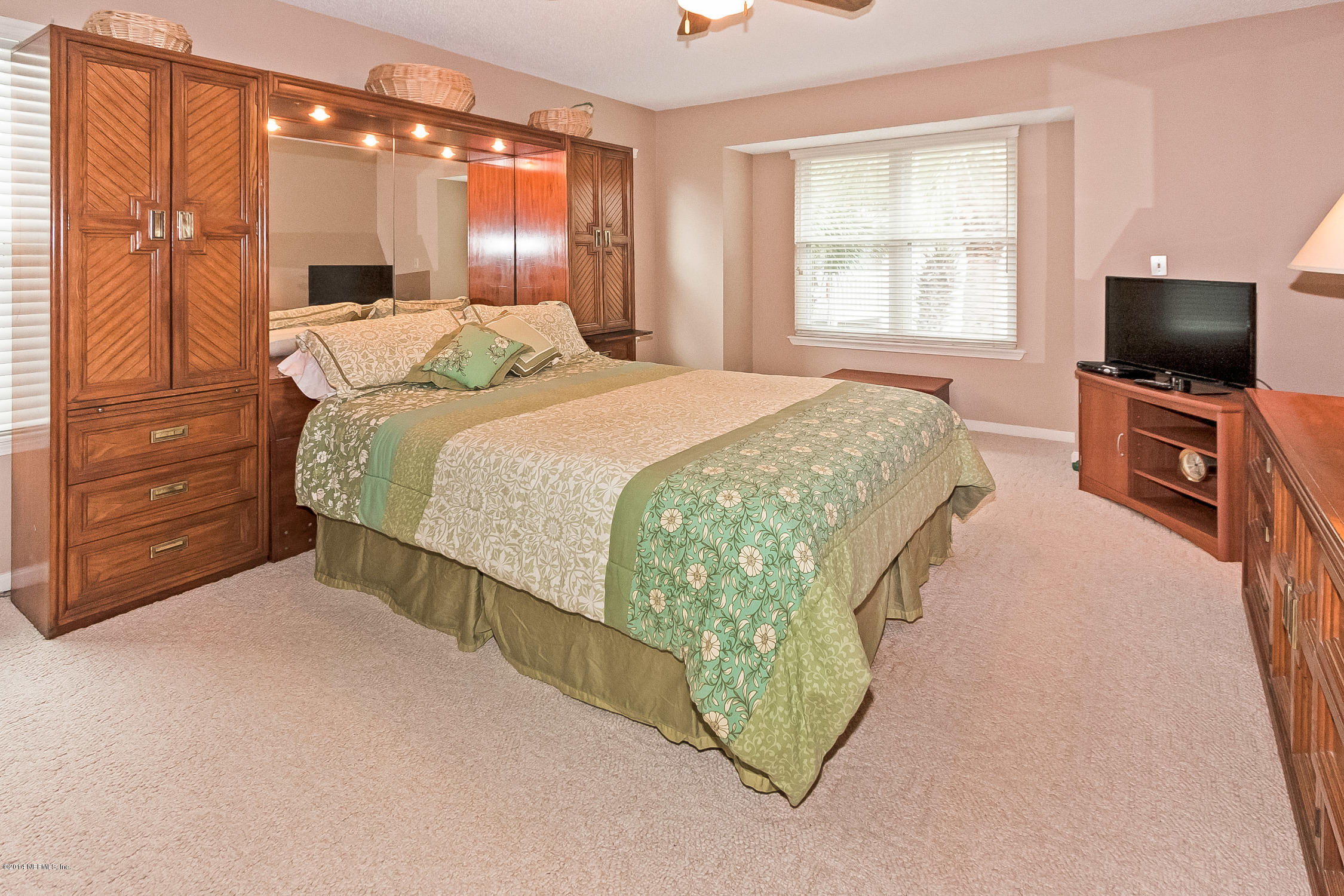 1969 Seminole Road Atlantic Beach, FL 32233 - Photo 18 of 36 a bedroom with a bed and flat screen tv