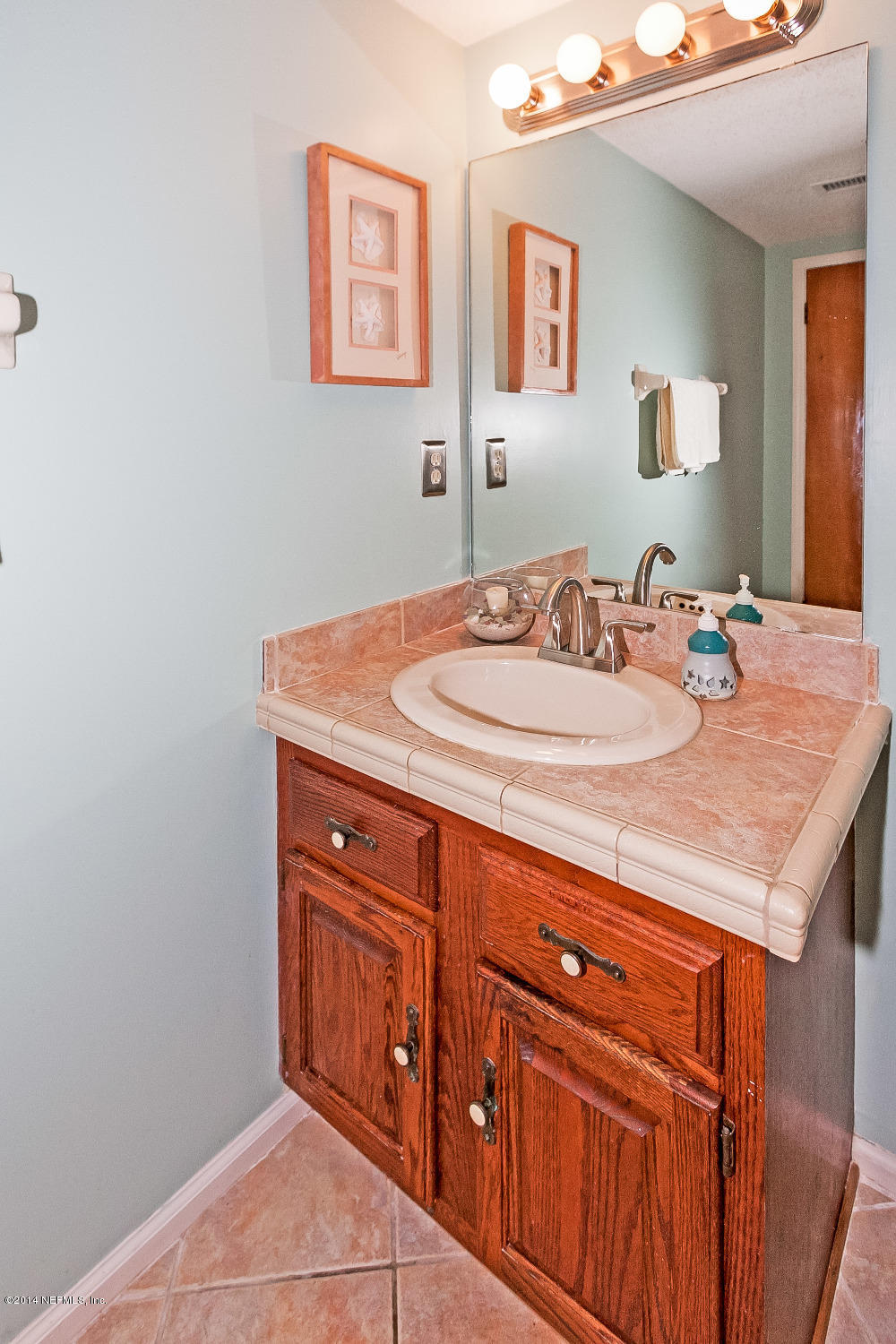 1969 Seminole Road Atlantic Beach, FL 32233 - Photo 20 of 36 a bathroom with a sink and a mirror