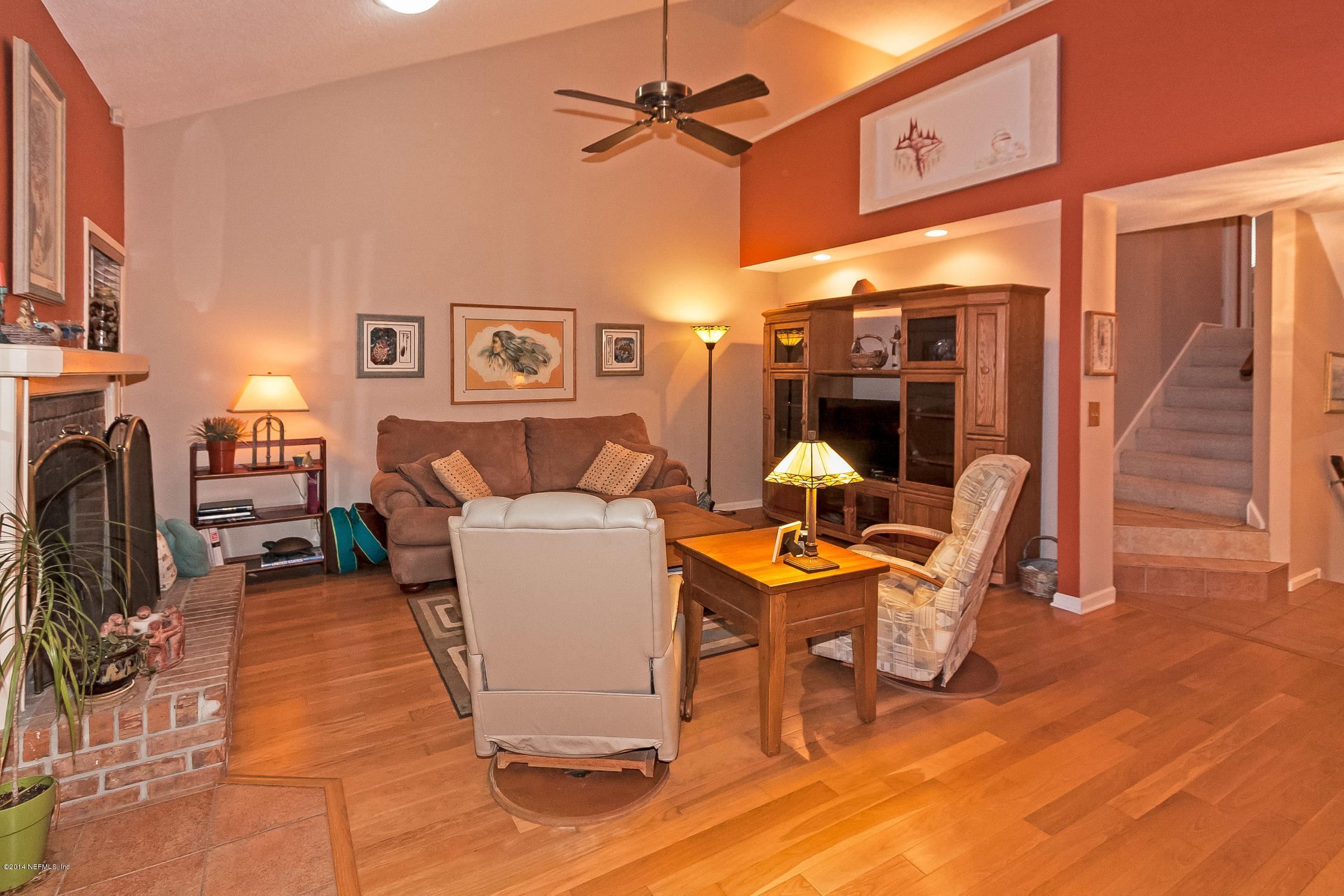 1969 Seminole Road Atlantic Beach, FL 32233 - Photo 8 of 36 a living room with furniture a fireplace and a chandelier
