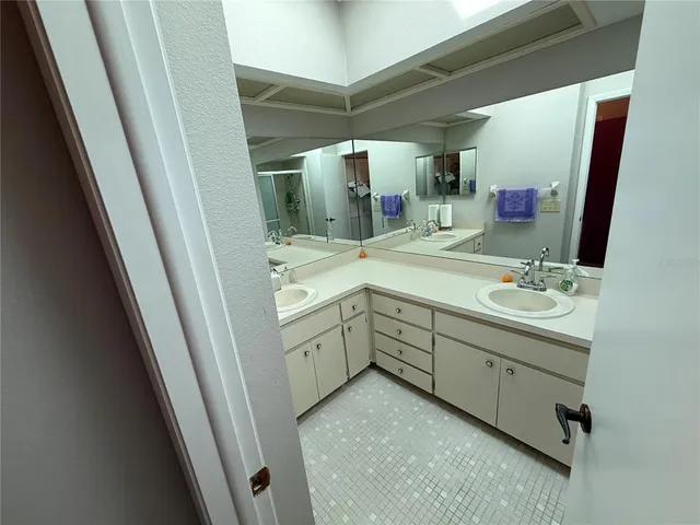 a bathroom with a double vanity sink and mirror