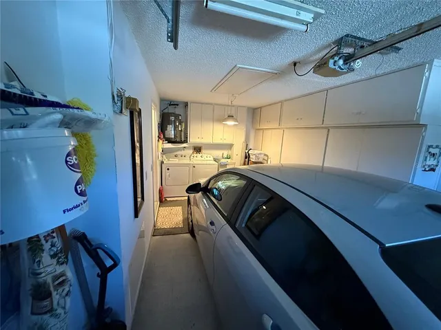 a view of a refrigerator in kitchen and utility room