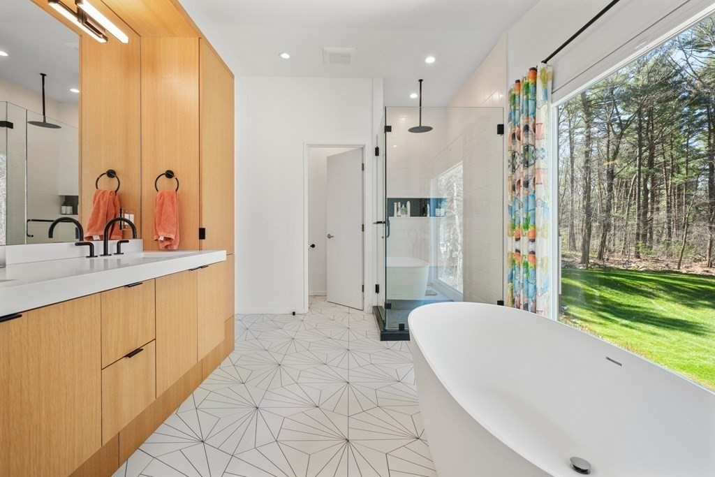 53 Beaver Road Weston, MA 02493 - Photo 19 of 38 a spacious bathroom with a double vanity sink a large mirror and shower