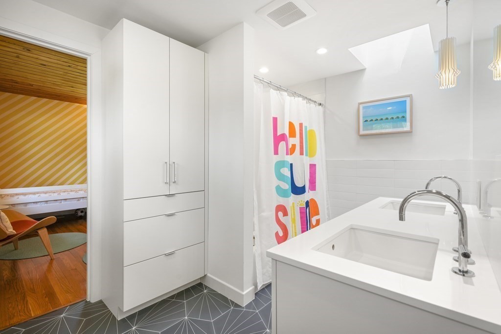 53 Beaver Road Weston, MA 02493 - Photo 21 of 38 a bathroom with a sink and a white cabinet