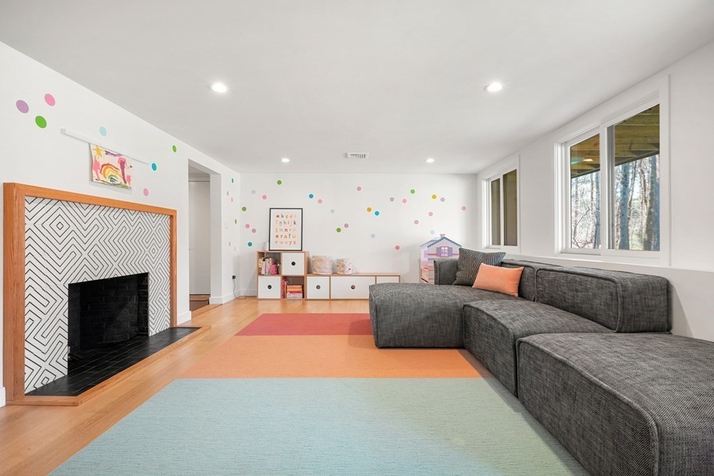 53 Beaver Road Weston, MA 02493 - Photo 28 of 38 a living room with furniture a fireplace and a window