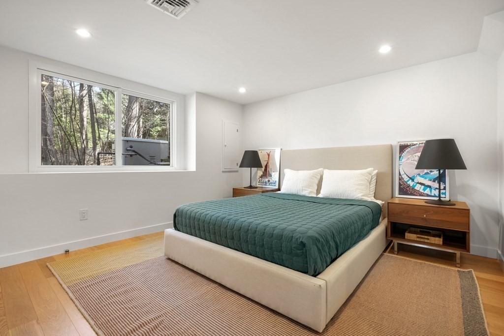 53 Beaver Road Weston, MA 02493 - Photo 29 of 38 a bedroom with a large bed and a window