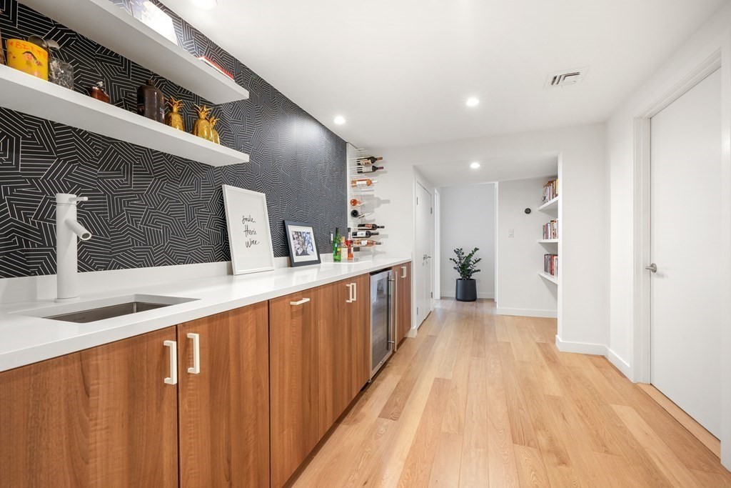 53 Beaver Road Weston, MA 02493 - Photo 31 of 38 a view of a hallway with wooden floor and a bathroom