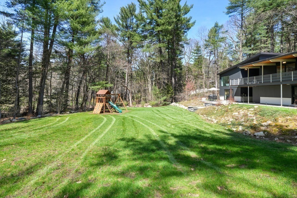 53 Beaver Road Weston, MA 02493 - Photo 36 of 38 a view of a backyard with a garden and trees
