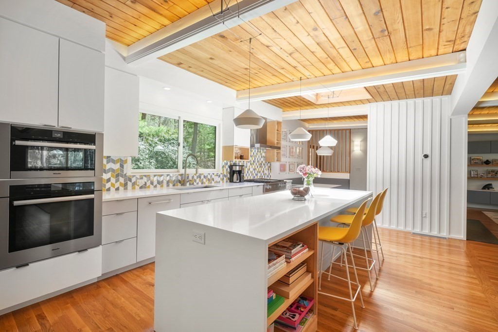 53 Beaver Road Weston, MA 02493 - Photo 6 of 38 a kitchen with stainless steel appliances granite countertop a stove a sink and a microwave