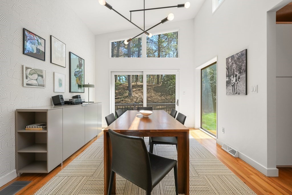 53 Beaver Road Weston, MA 02493 - Photo 10 of 38 a table and chairs in a room with wooden floor