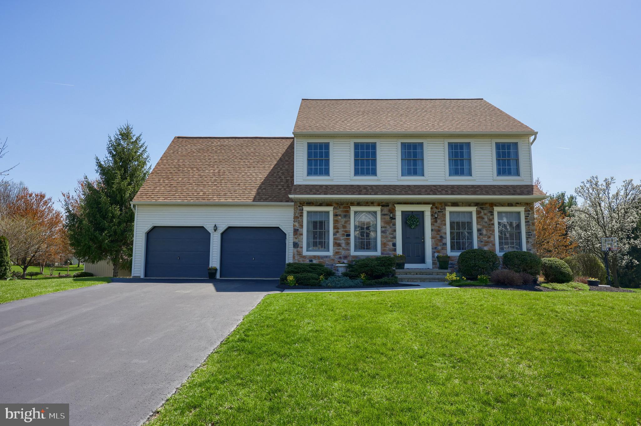 a front view of a house with garden and porch