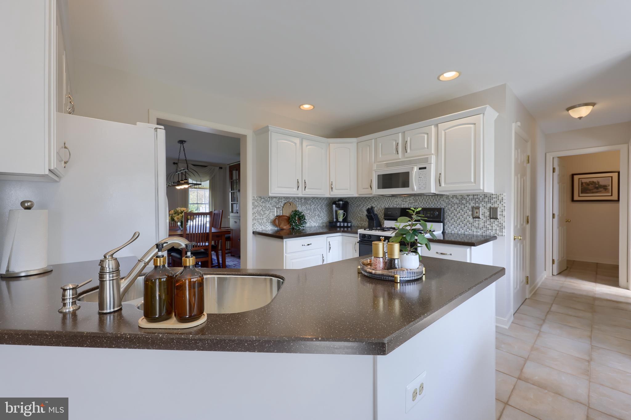 362 Squire Lane Lititz, PA 17543 - Photo 11 of 49 a kitchen with stainless steel appliances granite countertop a sink a stove and a refrigerator