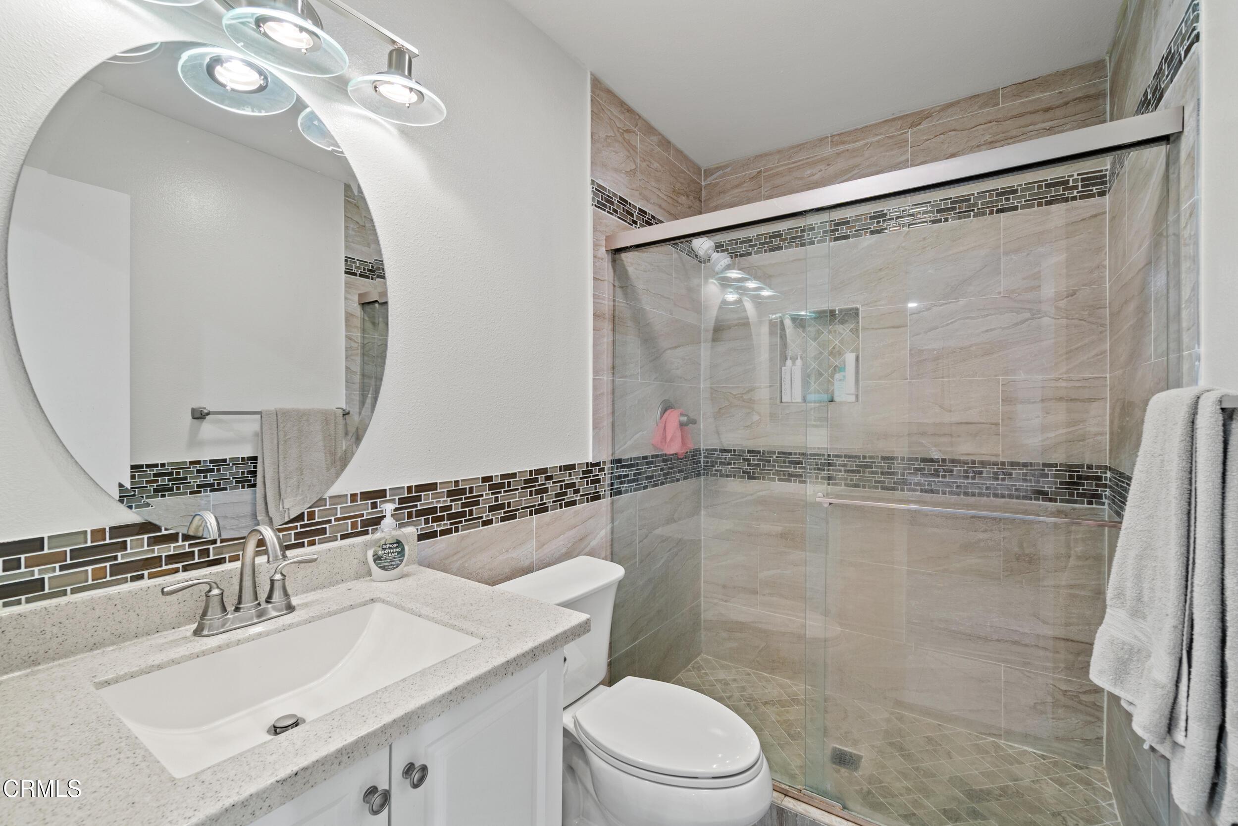 2226 North H Street Oxnard, CA 93036 - Photo 10 of 14 a bathroom with a sink vanity mirror and shower