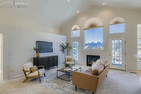 a living room with furniture fireplace and flat screen tv