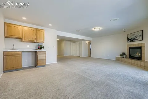 a view of a kitchen with a sink cabinets and a fireplace