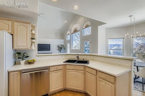 a kitchen with stainless steel appliances granite countertop a sink and cabinets