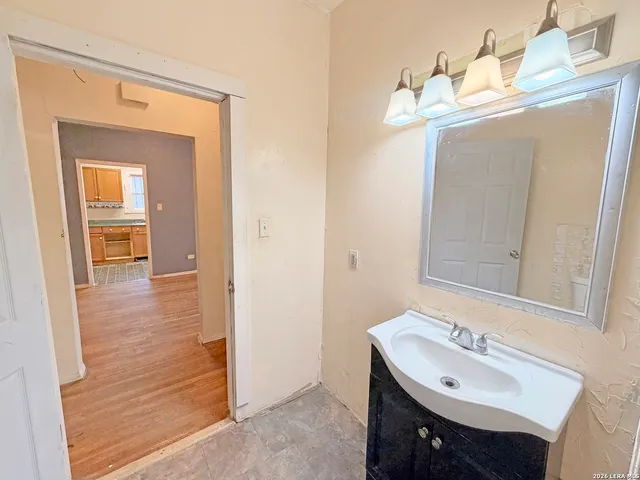 a bathroom with a sink a mirror and vanity
