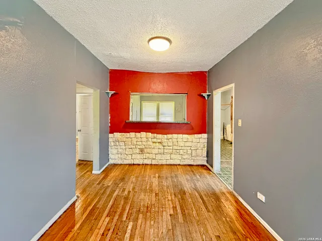 a view of hallway with wooden floor