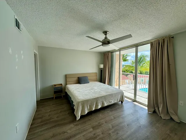 a bedroom with a bed and large window