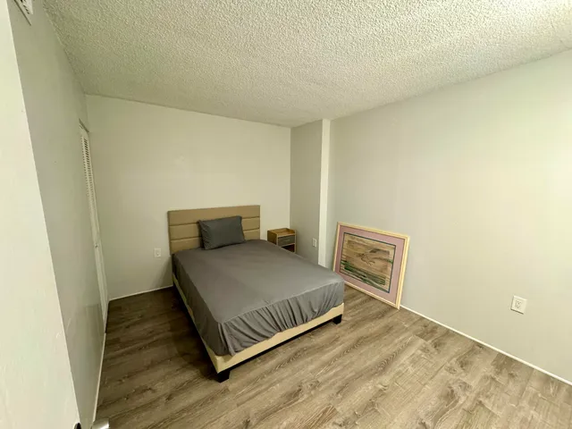 a room with a bench and wooden floor