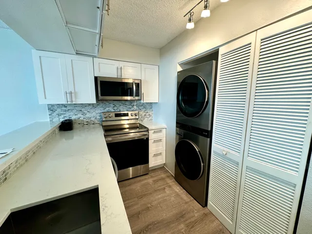 a kitchen with stainless steel appliances a sink and a refrigerator