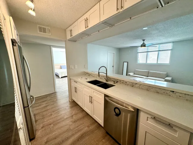 a kitchen with stainless steel appliances granite countertop a stove and a sink