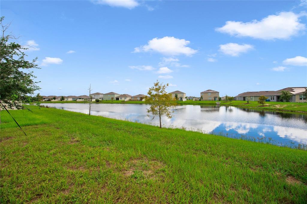 652 Greymount Street Davenport, FL 33837 - Photo 15 of 30 a view of a lake with houses in the background