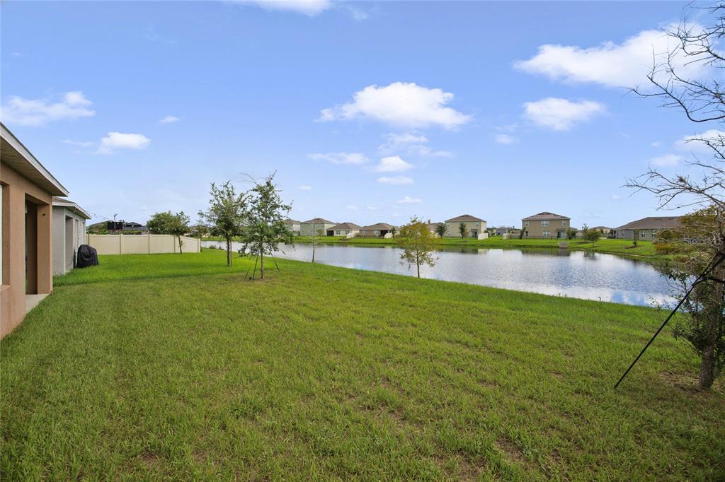 652 Greymount Street Davenport, FL 33837 - Photo 17 of 30 a view of a lake with houses in the background