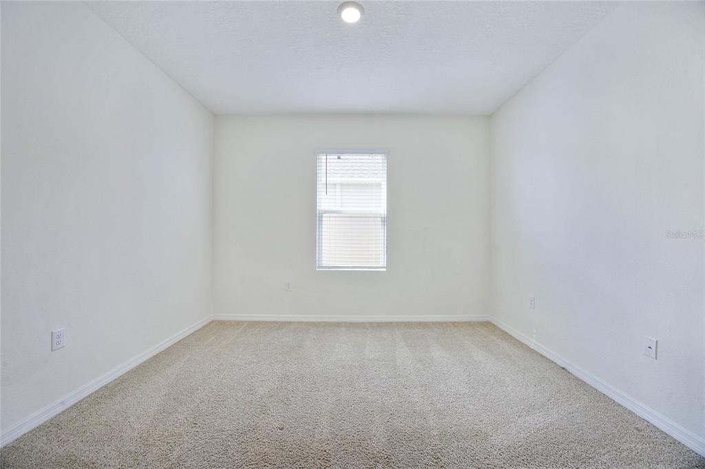 652 Greymount Street Davenport, FL 33837 - Photo 21 of 30 an empty room with a window