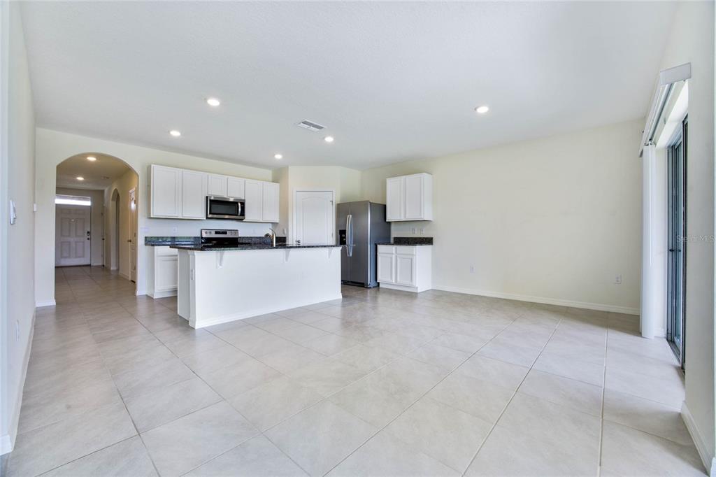 652 Greymount Street Davenport, FL 33837 - Photo 6 of 30 a large kitchen with cabinets and stainless steel appliances