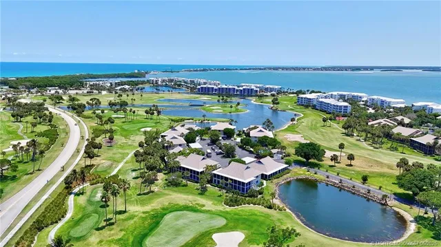 an aerial view of residential houses with outdoor space and swimming pool