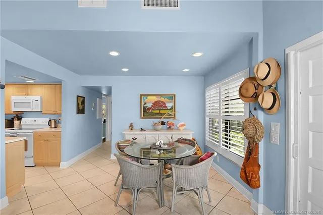 a kitchen with stainless steel appliances kitchen island granite countertop a refrigerator and a stove