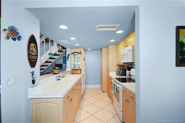 a utility room with sink dryer and washer