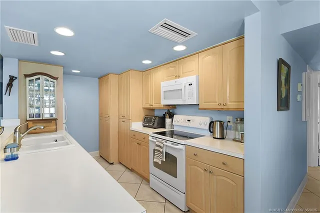 a living room with a large window and dining table