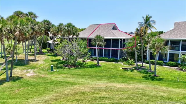 a front view of a house with a yard table and chairs