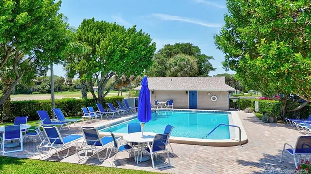 a view of backyard with outdoor seating and green space