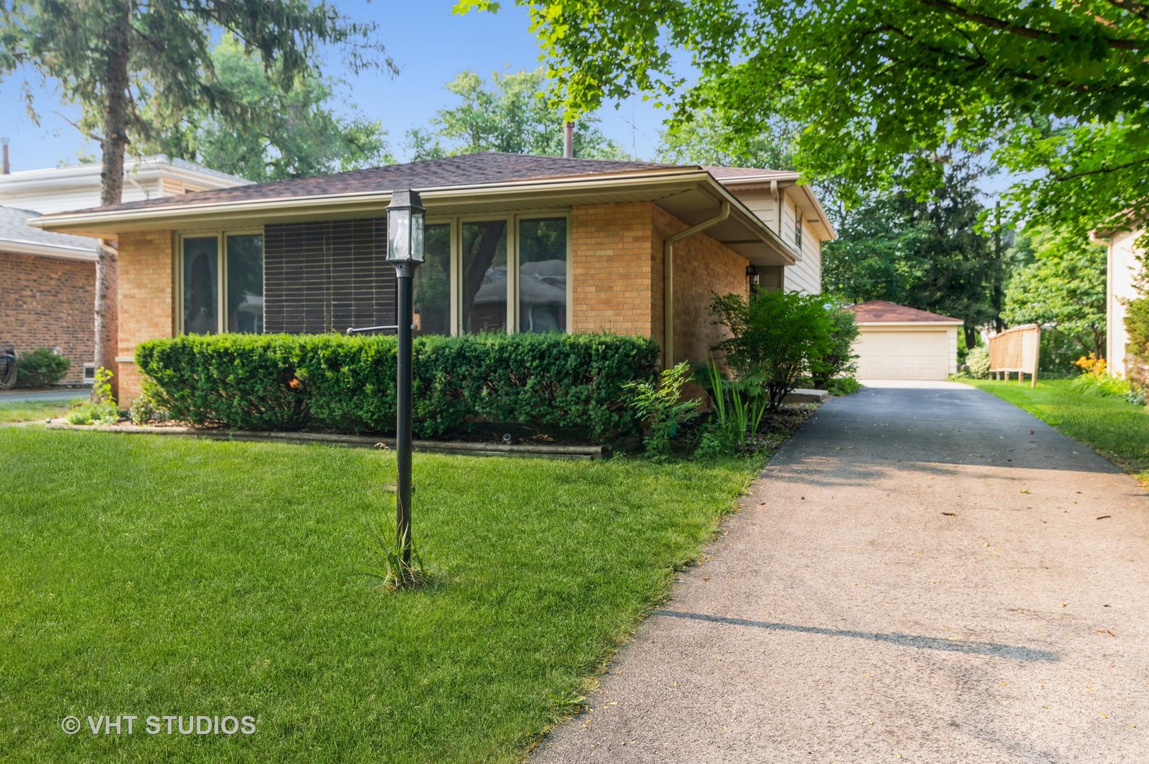 a view of a house with a yard and plants
