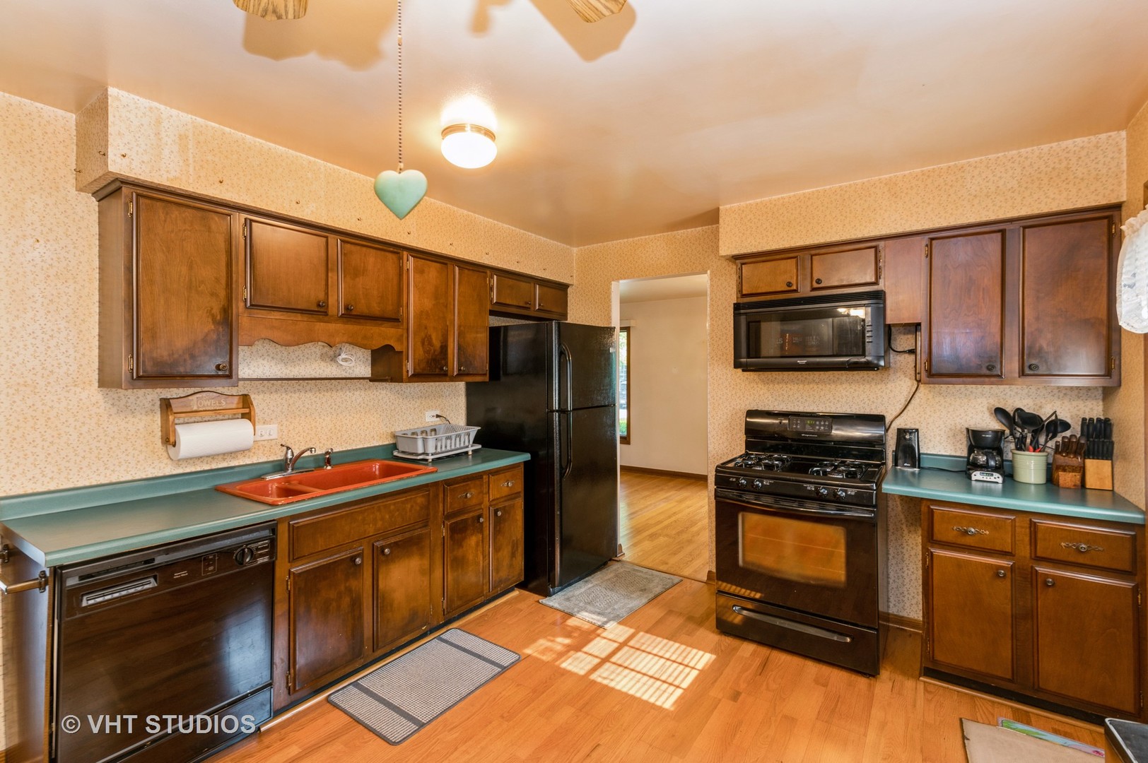 1232 Elder Road Homewood, IL 60430 - Photo 4 of 10 a kitchen with stainless steel appliances a stove sink microwave and cabinets