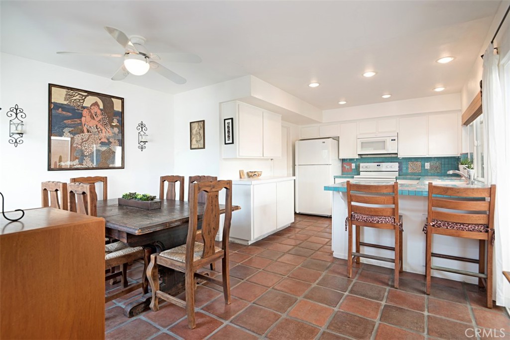 23761 Timor Bay Dana Point, CA 92629 - Photo 14 of 45 a kitchen with a dining table chairs and refrigerator