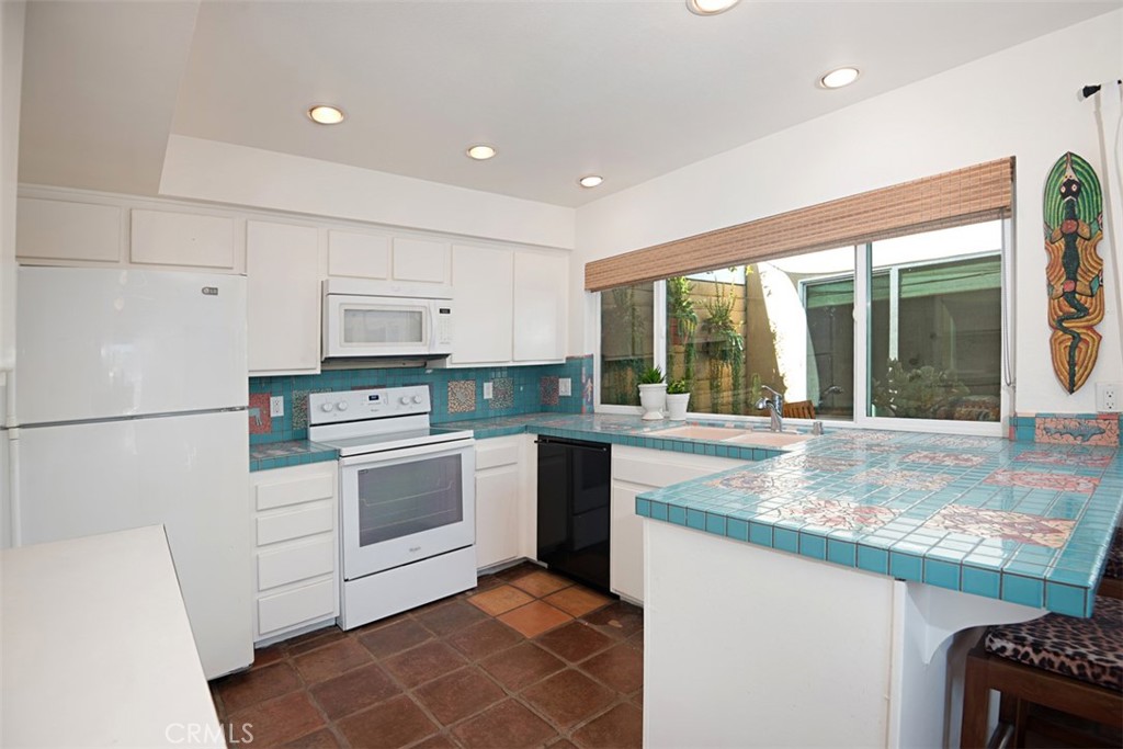 23761 Timor Bay Dana Point, CA 92629 - Photo 16 of 45 a kitchen with granite countertop white cabinets and white appliances