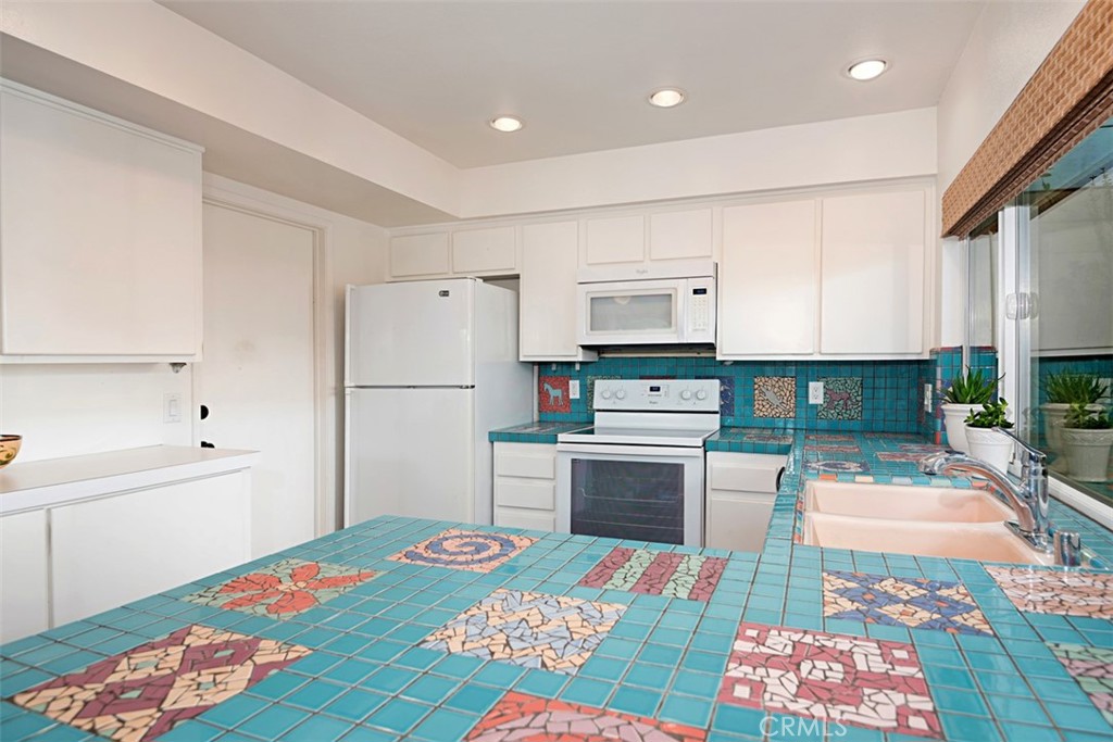 23761 Timor Bay Dana Point, CA 92629 - Photo 17 of 45 a kitchen with stainless steel appliances kitchen island granite countertop a refrigerator sink and stove