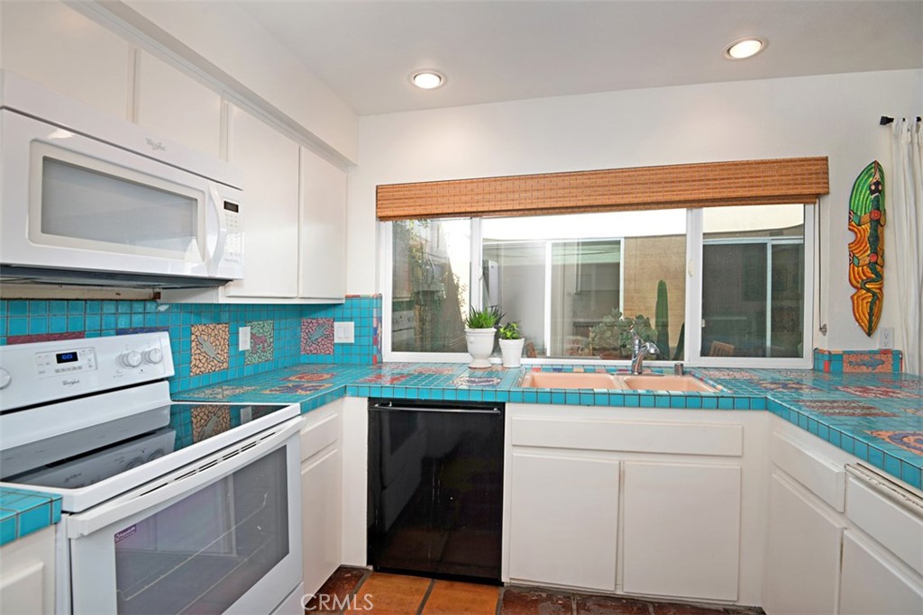 23761 Timor Bay Dana Point, CA 92629 - Photo 18 of 45 a kitchen with granite countertop white cabinets and white appliances