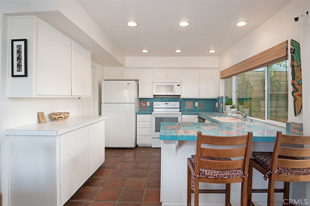 23761 Timor Bay Dana Point, CA 92629 - Photo 22 of 45 a kitchen with refrigerator and chairs