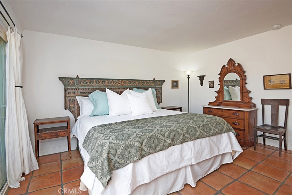 23761 Timor Bay Dana Point, CA 92629 - Photo 28 of 45 a bedroom with a bed and a potted plant on the dresser