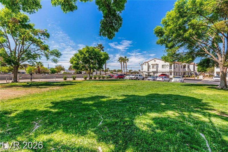 3318 North Decatur Boulevard, Unit 2152 Las Vegas, NV 89130 - Photo 53 of 58 A verdant community lawn offers ample green space amidst residential buildings under a bright sky.
