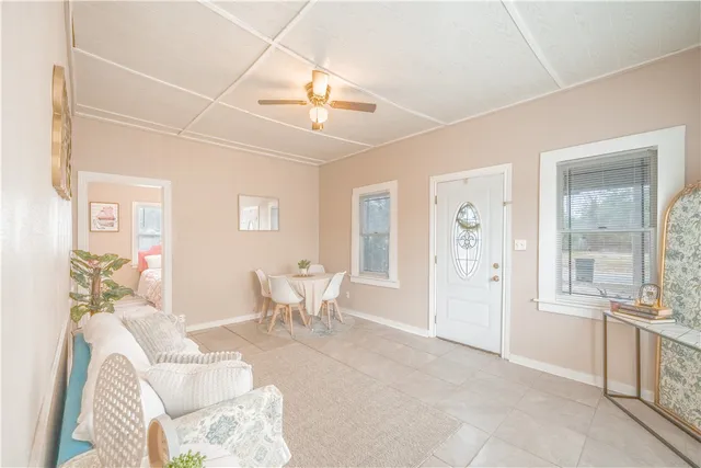 a living room with furniture a dining table and chairs with outer view